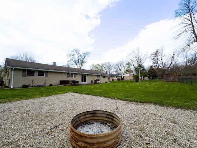 4604 Mayfield Dr, Kokomo, IN 46901 - rear view of property featuring an outdoor fire pit, a chimney, and brick siding