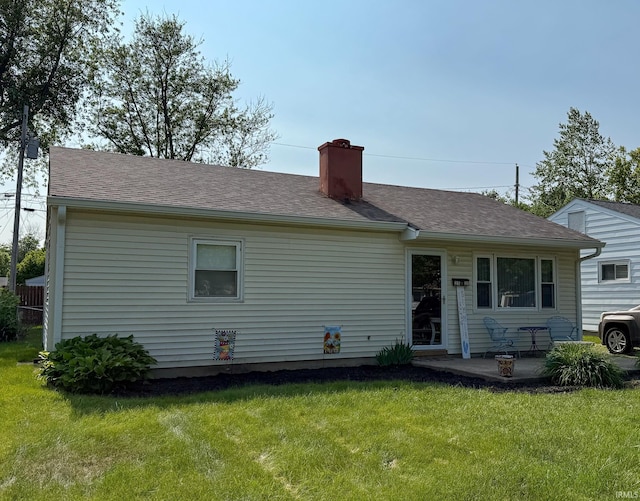 2520 Foxhall Dr, Lafayette, IN 47909 - rear view of property featuring a chimney, a lawn, a patio, and a shingled roof