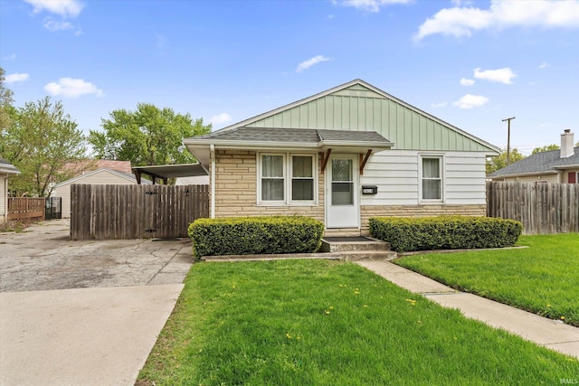 2614 N Main St, Mishawaka, IN 46545 - view of front of house featuring stone siding, driveway, board and batten siding, and roof with shingles