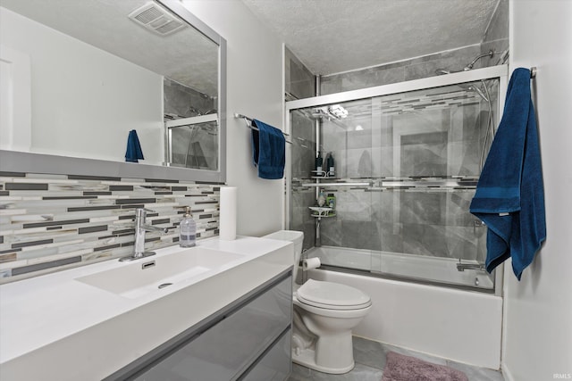 2614 N Main St, Mishawaka, IN 46545 - full bathroom featuring toilet, decorative backsplash, combined bath / shower with glass door, vanity, and a textured ceiling