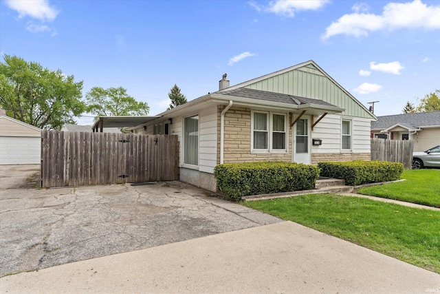 2614 N Main St, Mishawaka, IN 46545 - view of front of property with board and batten siding, stone siding, and a chimney