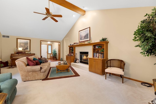 1114 Packard Pl, Auburn, IN 46706 - living area with light colored carpet, a brick fireplace, beam ceiling, a ceiling fan, and baseboards