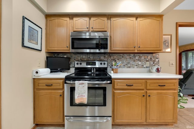 1114 Packard Pl, Auburn, IN 46706 - kitchen with stainless steel appliances, light countertops, tasteful backsplash, and light brown cabinets
