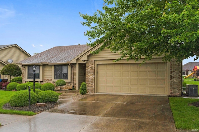 1114 Packard Pl, Auburn, IN 46706 - view of front of house featuring brick siding, concrete driveway, central AC unit, and a garage
