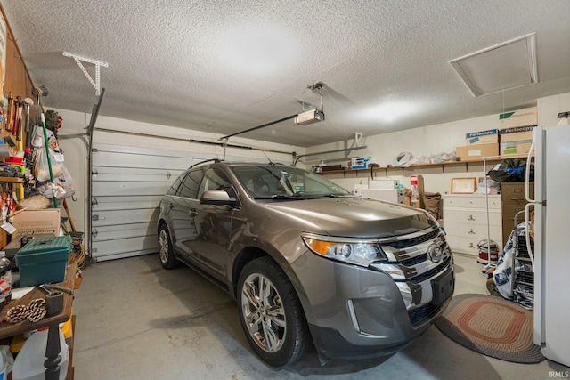 1114 Packard Pl, Auburn, IN 46706 - garage featuring a garage door opener and freestanding refrigerator