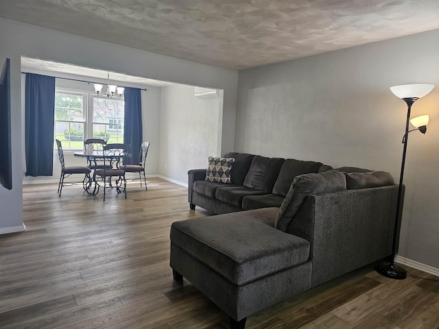 1326 Stag Dr, Fort Wayne, IN 46804 - living area with a chandelier, dark wood-type flooring, baseboards, and a textured ceiling