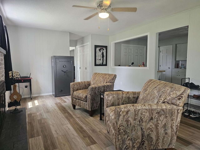 1326 Stag Dr, Fort Wayne, IN 46804 - living area featuring a ceiling fan, wood finished floors, and a brick fireplace