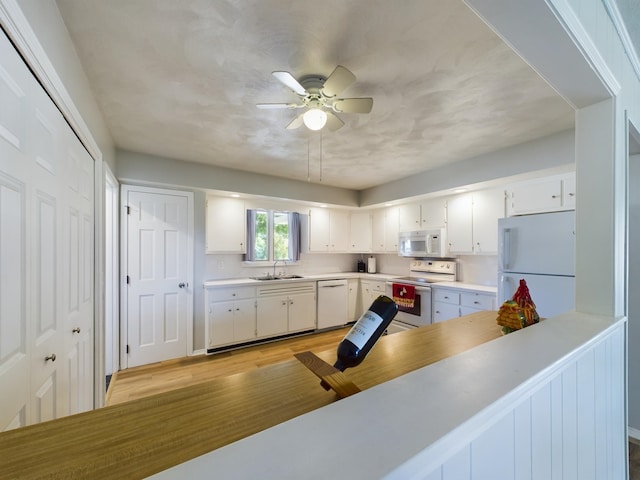 1326 Stag Dr, Fort Wayne, IN 46804 - kitchen featuring white appliances, a sink, light wood finished floors, a ceiling fan, and light countertops