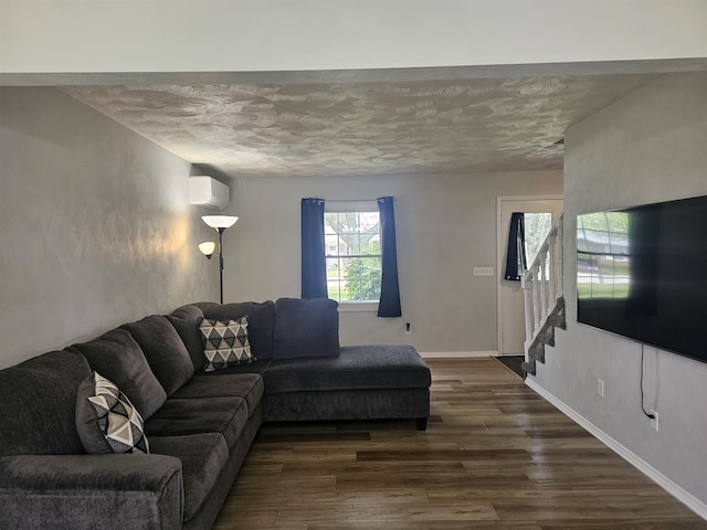 1326 Stag Dr, Fort Wayne, IN 46804 - living room with stairway, dark wood finished floors, a wall mounted air conditioner, a textured ceiling, and baseboards