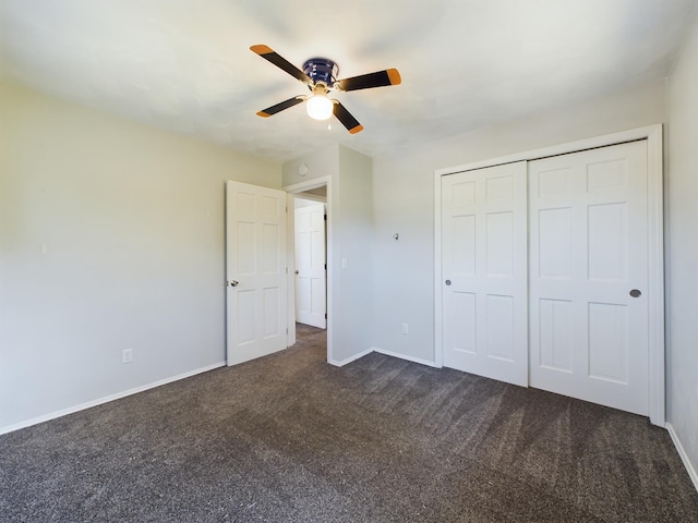 1326 Stag Dr, Fort Wayne, IN 46804 - unfurnished bedroom with dark colored carpet, baseboards, a closet, and a ceiling fan