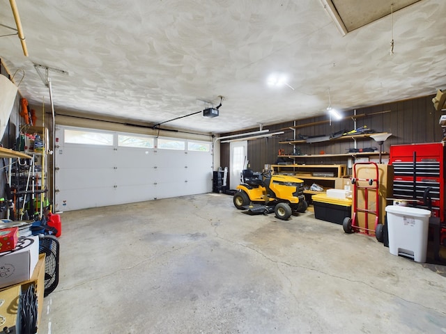 1326 Stag Dr, Fort Wayne, IN 46804 - garage with a garage door opener and wooden walls