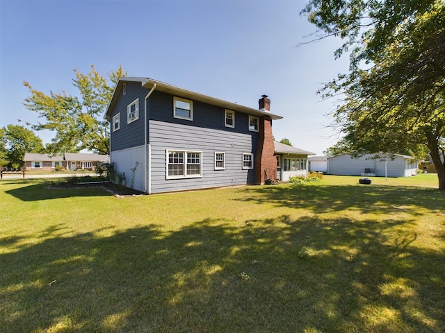 1326 Stag Dr, Fort Wayne, IN 46804 - back of house featuring a chimney and a lawn