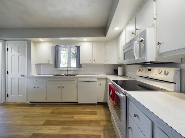 1326 Stag Dr, Fort Wayne, IN 46804 - kitchen featuring white appliances, a sink, light countertops, white cabinetry, and recessed lighting