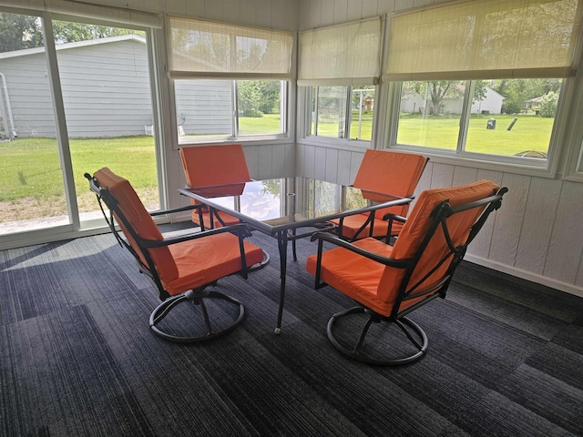 1326 Stag Dr, Fort Wayne, IN 46804 - sunroom with carpet floors, outdoor dining space, plenty of natural light, and wood walls