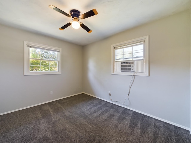 1326 Stag Dr, Fort Wayne, IN 46804 - unfurnished room with healthy amount of natural light, dark carpet, a ceiling fan, and baseboards