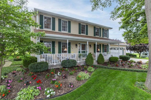 54363 Adrian Ct, Osceola, IN 46561 - colonial home featuring covered porch, an attached garage, and a front lawn
