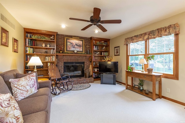 54363 Adrian Ct, Osceola, IN 46561 - living room with ceiling fan, a brick fireplace, baseboards, built in shelves, and carpet flooring