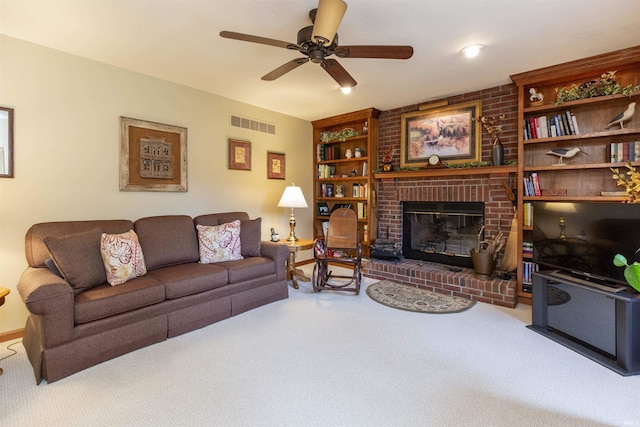 54363 Adrian Ct, Osceola, IN 46561 - living area featuring carpet flooring, ceiling fan, a brick fireplace, built in features, and baseboards