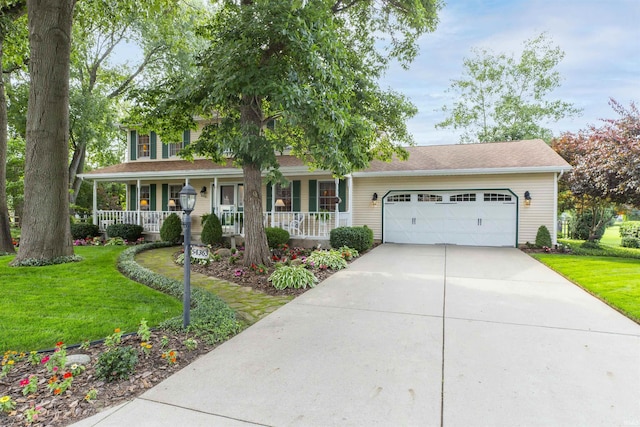 54363 Adrian Ct, Osceola, IN 46561 - view of front of house with a garage, a porch, a front yard, and driveway