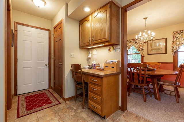 54363 Adrian Ct, Osceola, IN 46561 - kitchen with plenty of natural light, a chandelier, and brown cabinetry
