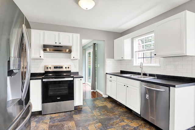 843 S Lantern Ln, Ellettsville, IN 47401 - kitchen with appliances with stainless steel finishes, a sink, under cabinet range hood, dark countertops, and white cabinets