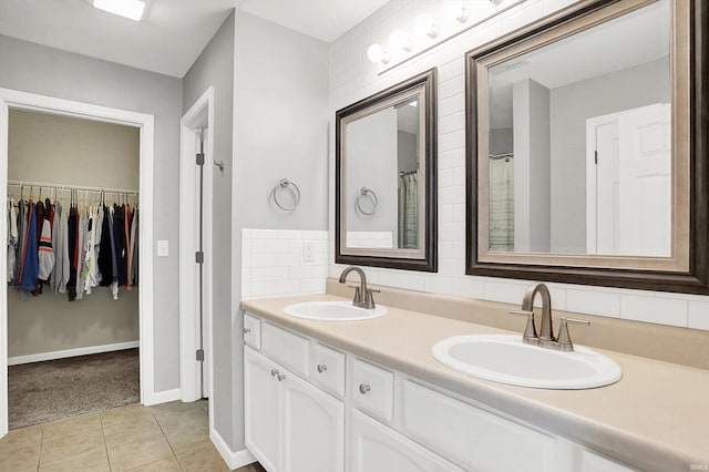 843 S Lantern Ln, Ellettsville, IN 47401 - full bathroom with double vanity, baseboards, a walk in closet, and tile patterned floors