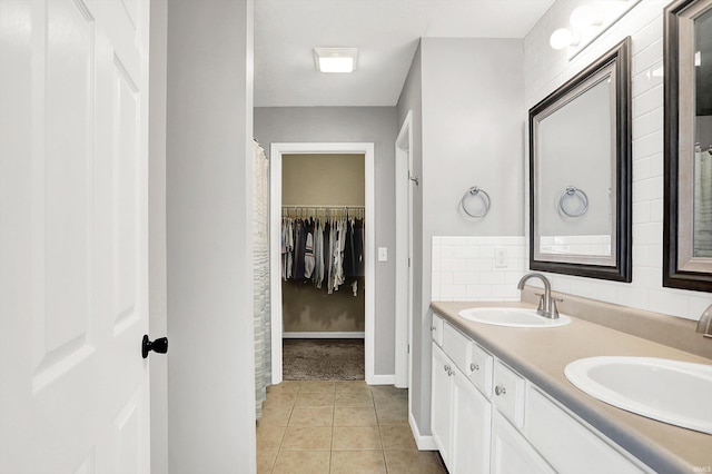 843 S Lantern Ln, Ellettsville, IN 47401 - bathroom with double vanity, tile patterned floors, baseboards, and a walk in closet
