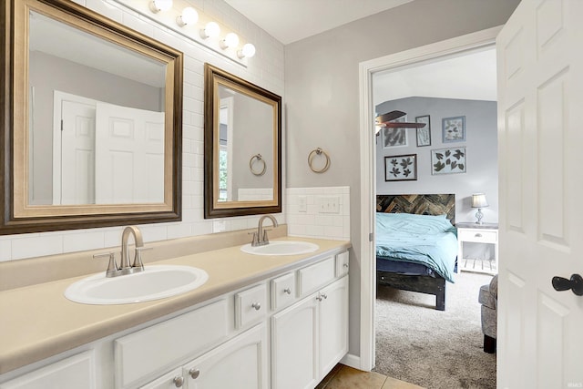 843 S Lantern Ln, Ellettsville, IN 47401 - full bathroom featuring double vanity, connected bathroom, tile patterned floors, and a ceiling fan