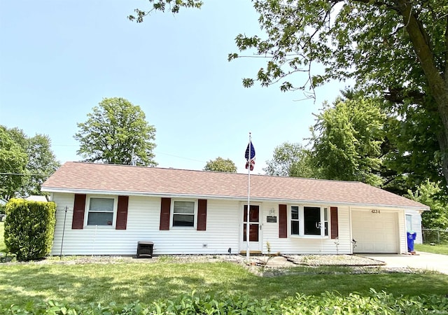 4234 Oak St, Woodburn, IN 46797 - ranch-style house featuring a garage, driveway, and a front lawn
