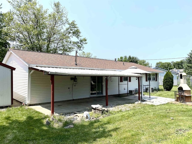4234 Oak St, Woodburn, IN 46797 - back of house featuring a lawn, a patio area, a carport, and a shingled roof
