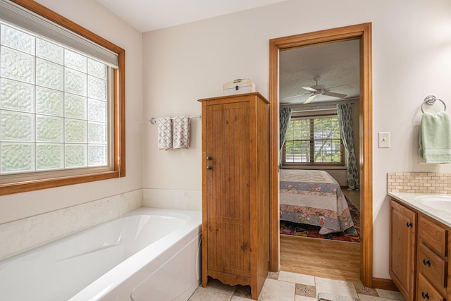 58078 Windsong Dr, Elkhart, IN 46517 - bathroom with vanity, connected bathroom, a bath, and ceiling fan