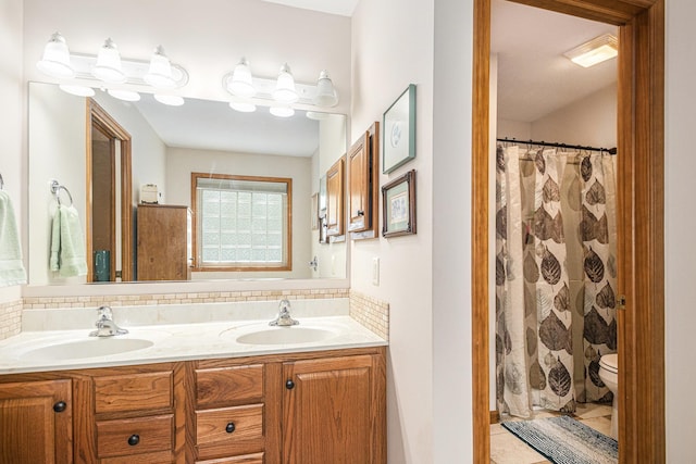 58078 Windsong Dr, Elkhart, IN 46517 - full bathroom featuring tasteful backsplash, double vanity, toilet, and tile patterned floors