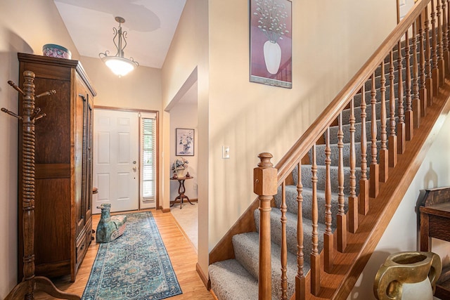 58078 Windsong Dr, Elkhart, IN 46517 - entrance foyer with light wood finished floors, stairway, high vaulted ceiling, and baseboards