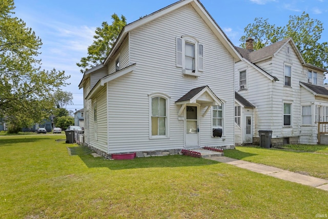 315 Division St, Elkhart, IN 46516 - view of front facade with a front yard and a chimney