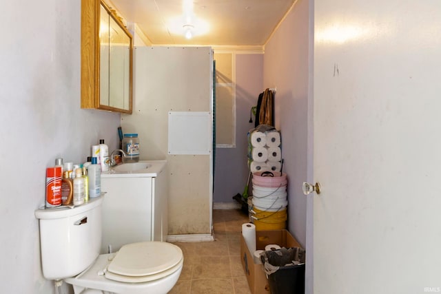 315 Division St, Elkhart, IN 46516 - bathroom featuring toilet, vanity, and tile patterned flooring