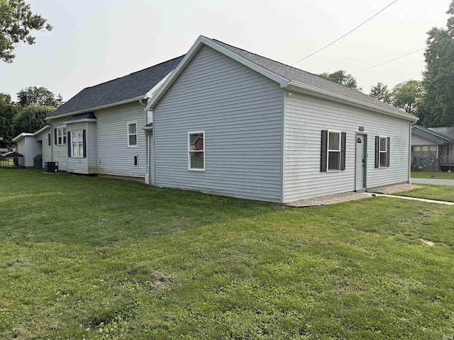 325 W Pine St, Princeton, IN 47670 - view of property exterior with a yard, central air condition unit, and roof with shingles