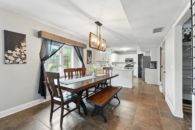 2906 Easton Ridge Pl, Fort Wayne, IN 46818 - dining space featuring a textured ceiling, a chandelier, baseboards, and dark tile patterned floors