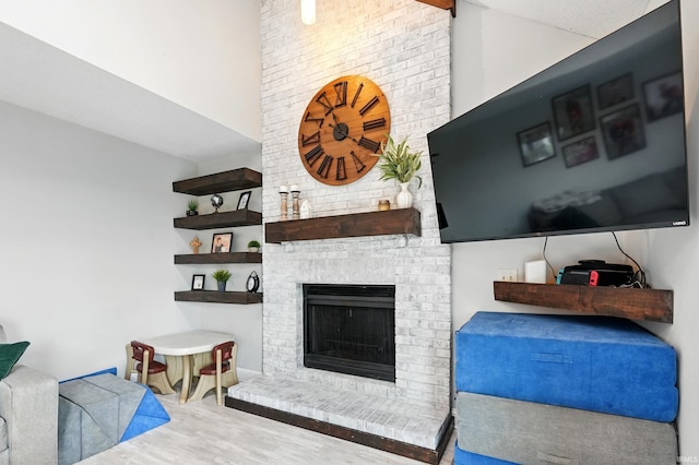 2906 Easton Ridge Pl, Fort Wayne, IN 46818 - living area featuring wood finished floors, a fireplace, and a towering ceiling