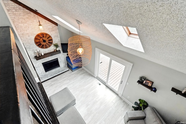 2906 Easton Ridge Pl, Fort Wayne, IN 46818 - stairway with a textured ceiling, a skylight, lofted ceiling, wood finished floors, and baseboards