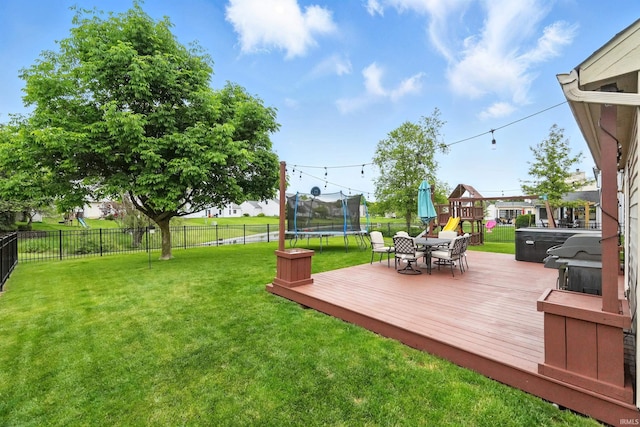 2906 Easton Ridge Pl, Fort Wayne, IN 46818 - view of yard featuring a trampoline, a wooden deck, outdoor dining space, and a playground