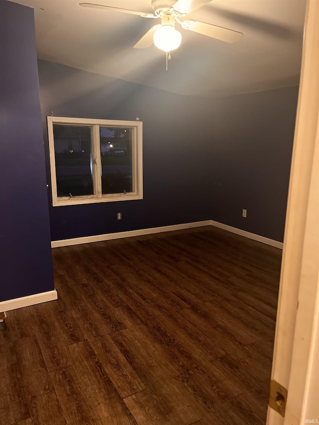 303 E N St, Winslow, IN 47598 - unfurnished room featuring dark wood finished floors, ceiling fan, and baseboards