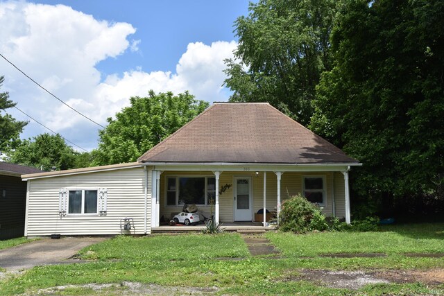 303 E N St, Winslow, IN 47598 - view of front of house featuring covered porch, a front lawn, and a shingled roof