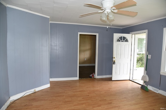303 E N St, Winslow, IN 47598 - empty room featuring wood finished floors, a ceiling fan, ornamental molding, baseboards, and wooden walls