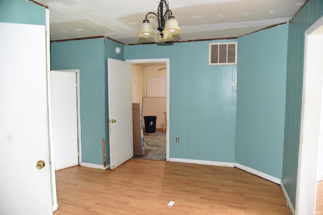 303 E N St, Winslow, IN 47598 - unfurnished room with light wood finished floors, a chandelier, and baseboards