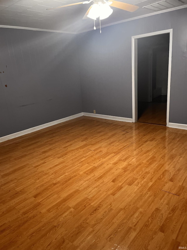 303 E N St, Winslow, IN 47598 - spare room featuring ornamental molding, light wood-type flooring, ceiling fan, and baseboards