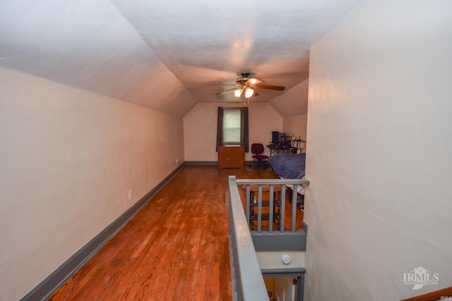 1816 W 13th St, Muncie, IN 47302 - corridor featuring wood finished floors, vaulted ceiling, and baseboards