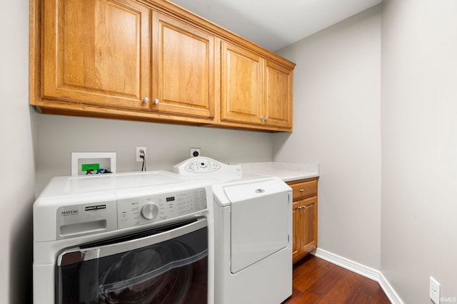 3564 Westport Dr, New Haven, IN 46774 - washroom with cabinet space, washing machine and clothes dryer, baseboards, and dark wood-type flooring