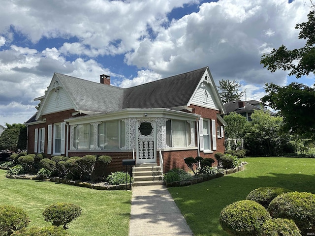 27 N Edwards St, Worthington, IN 47471 - victorian house with brick siding, a chimney, entry steps, a front yard, and roof with shingles