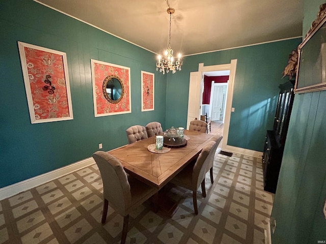 27 N Edwards St, Worthington, IN 47471 - dining room featuring tile patterned floors, a chandelier, baseboards, and ornamental molding