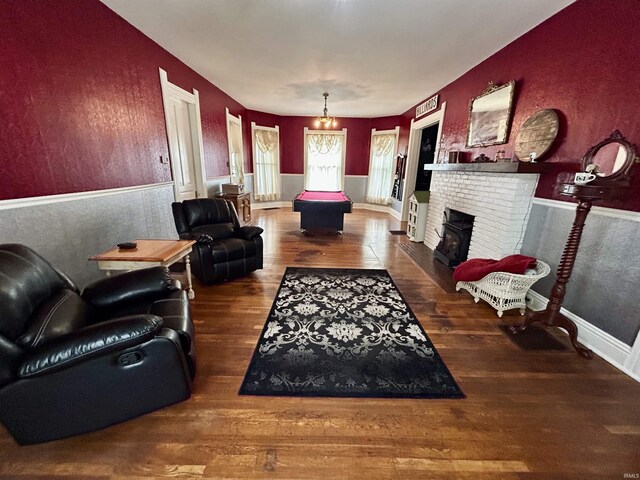 27 N Edwards St, Worthington, IN 47471 - living room with wood finished floors and a brick fireplace